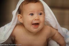 A happy baby under blanket; Size=240 pixels wide